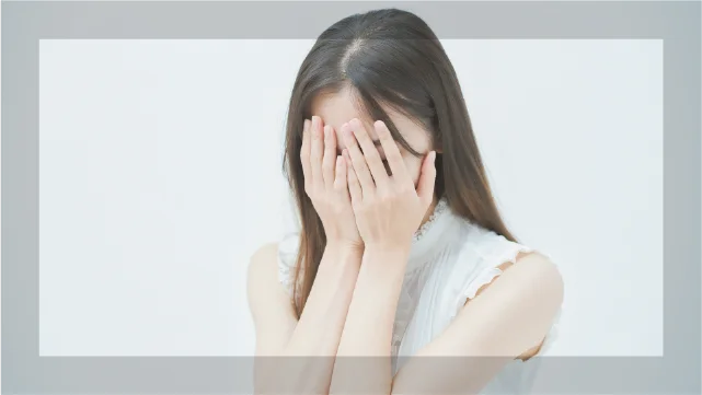 製剤選びに悩み後悔しているような女性、手で顔を覆っている